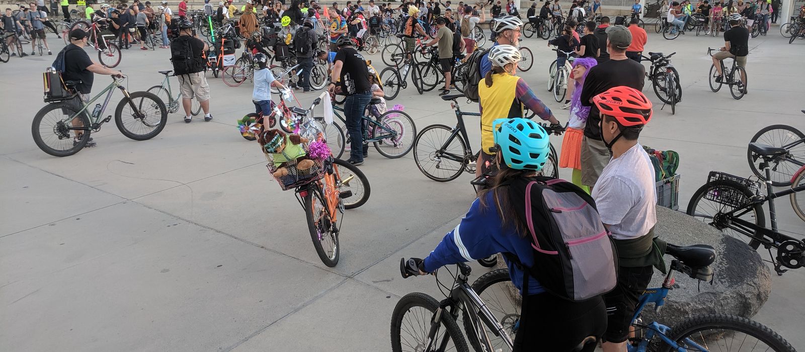 Hundreds of riders with bikes gathering at San Jose City Hall plaza before the monthly San Jose Bike Party group ride