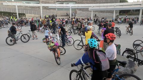 Hundreds of riders with bikes gathering at San Jose City Hall plaza before the monthly San Jose Bike Party group ride